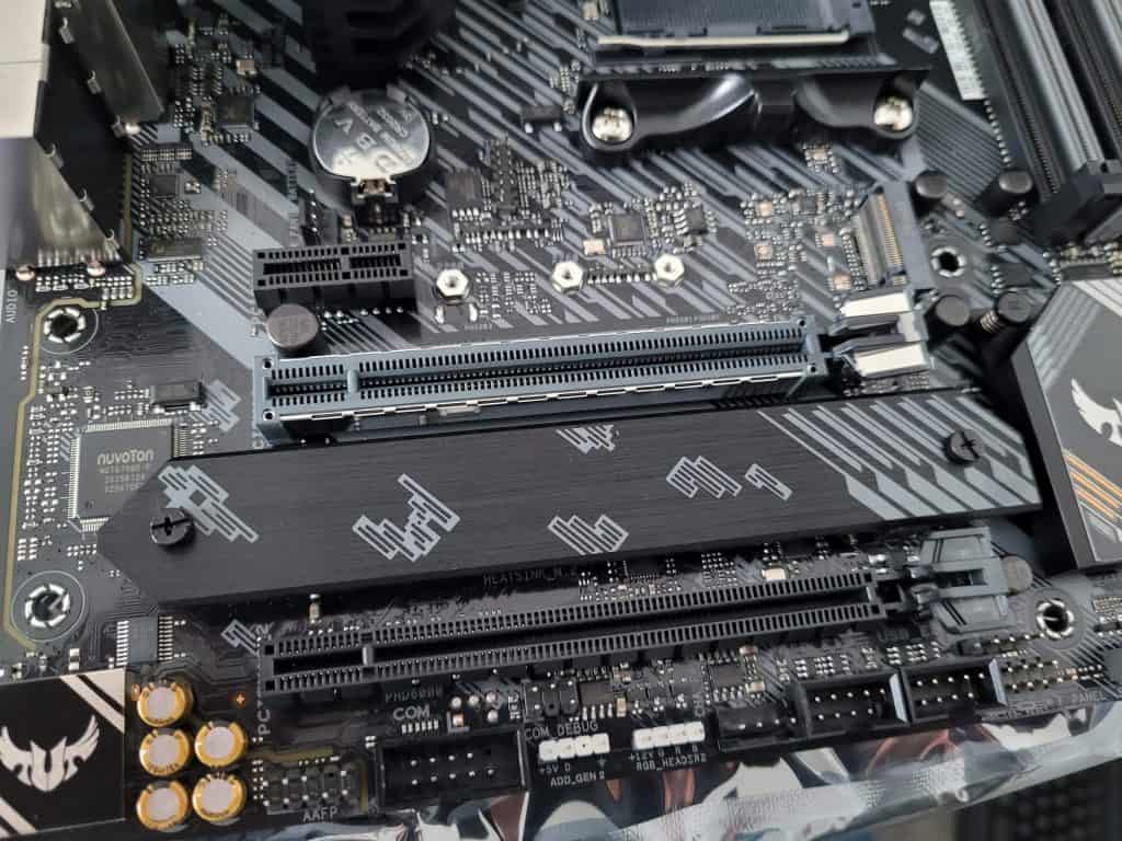 A motherboard with bare M.2 slot and also a separate M.2 heatsink cover