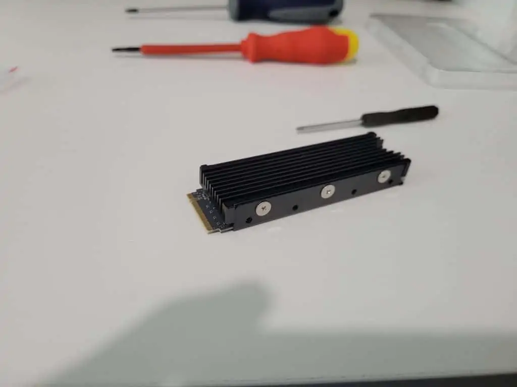 An M.2 SSD with a screwed in heatsink attached