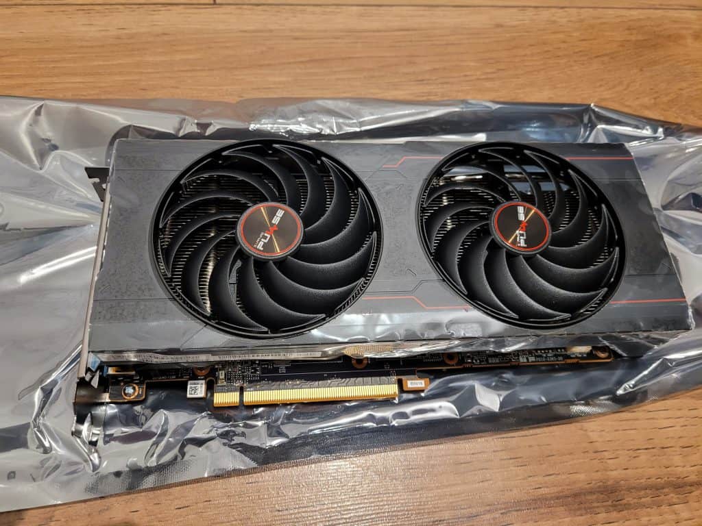 A Sapphire Pulse RX 6700 XT graphics card resting on an anti static bag