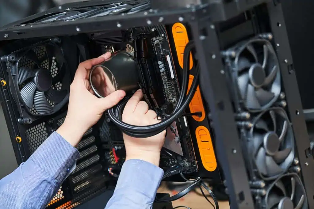 Someone installing an all in one AIO liquid cooler onto the CPU