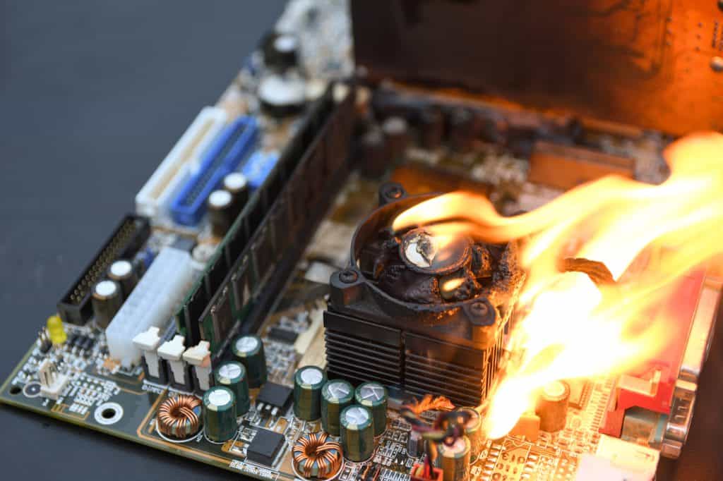 A CPU cooler on fire mounted on a motherboard