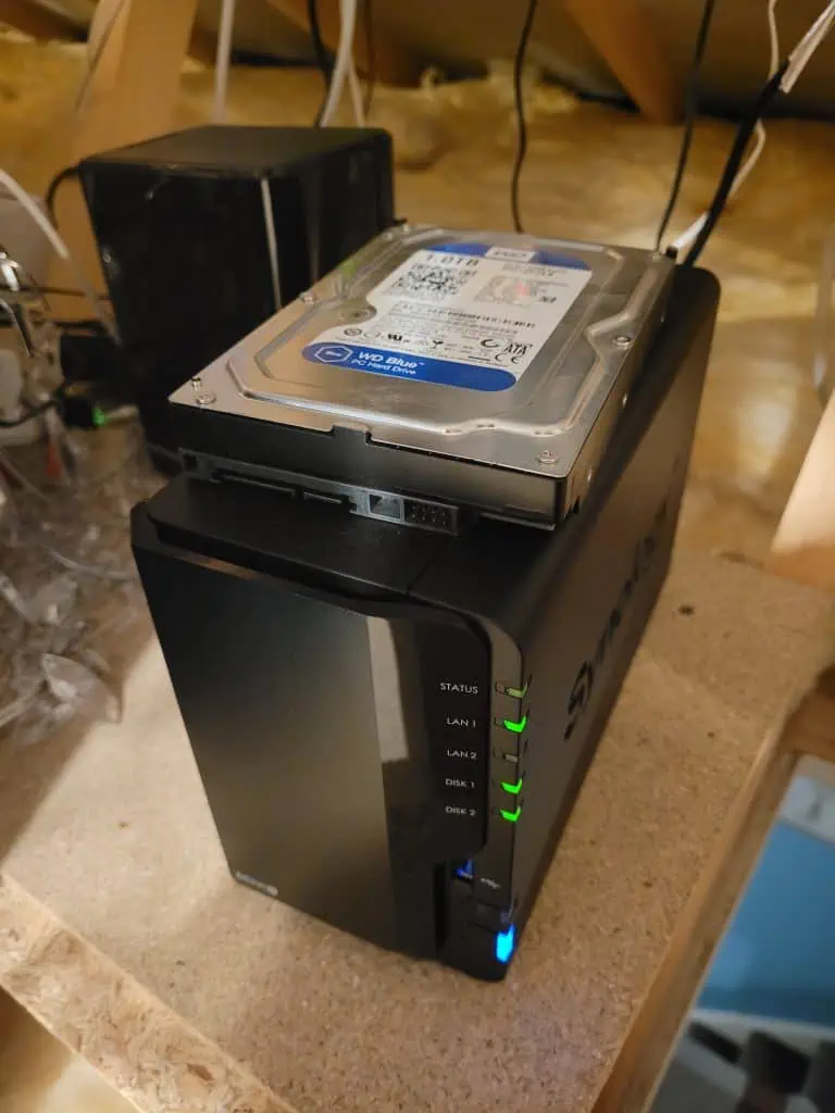 A picture of my Synology NAS with its old 1TB sitting on top of it