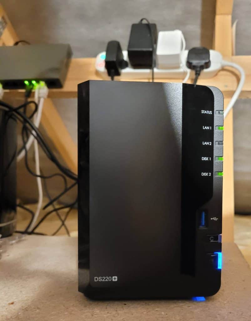 My Synology DS220 NAS with two internal drives connected to a network switch