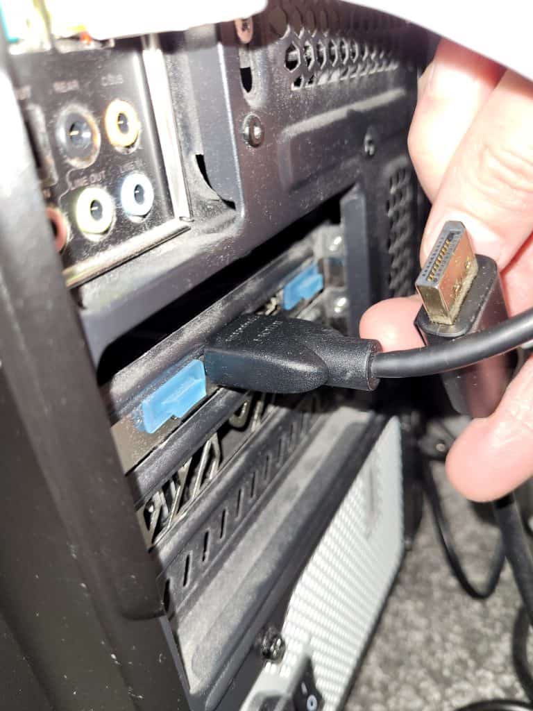 A plugged in HDMI cable and unplugged DP cable going to the back of my GPU