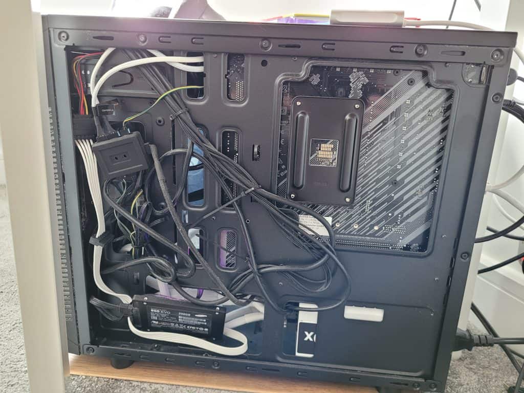 The hidden cable routing area behind the motherboard tray in my case